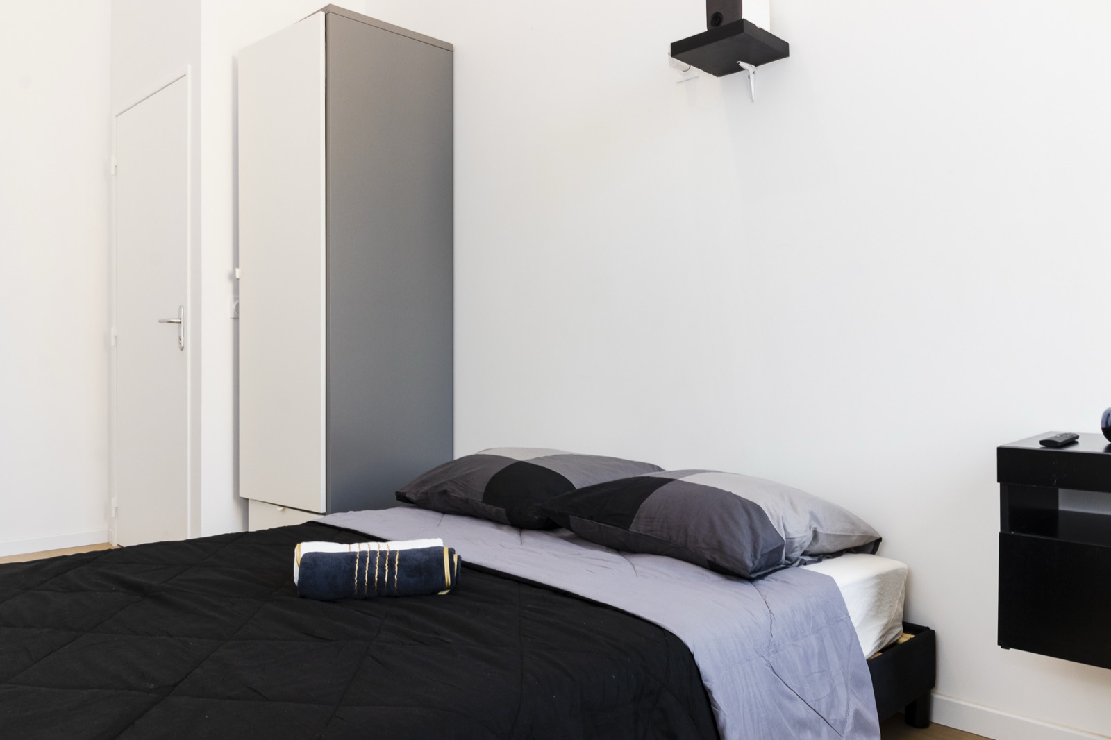 Furnished bedroom with bed and wardrobe