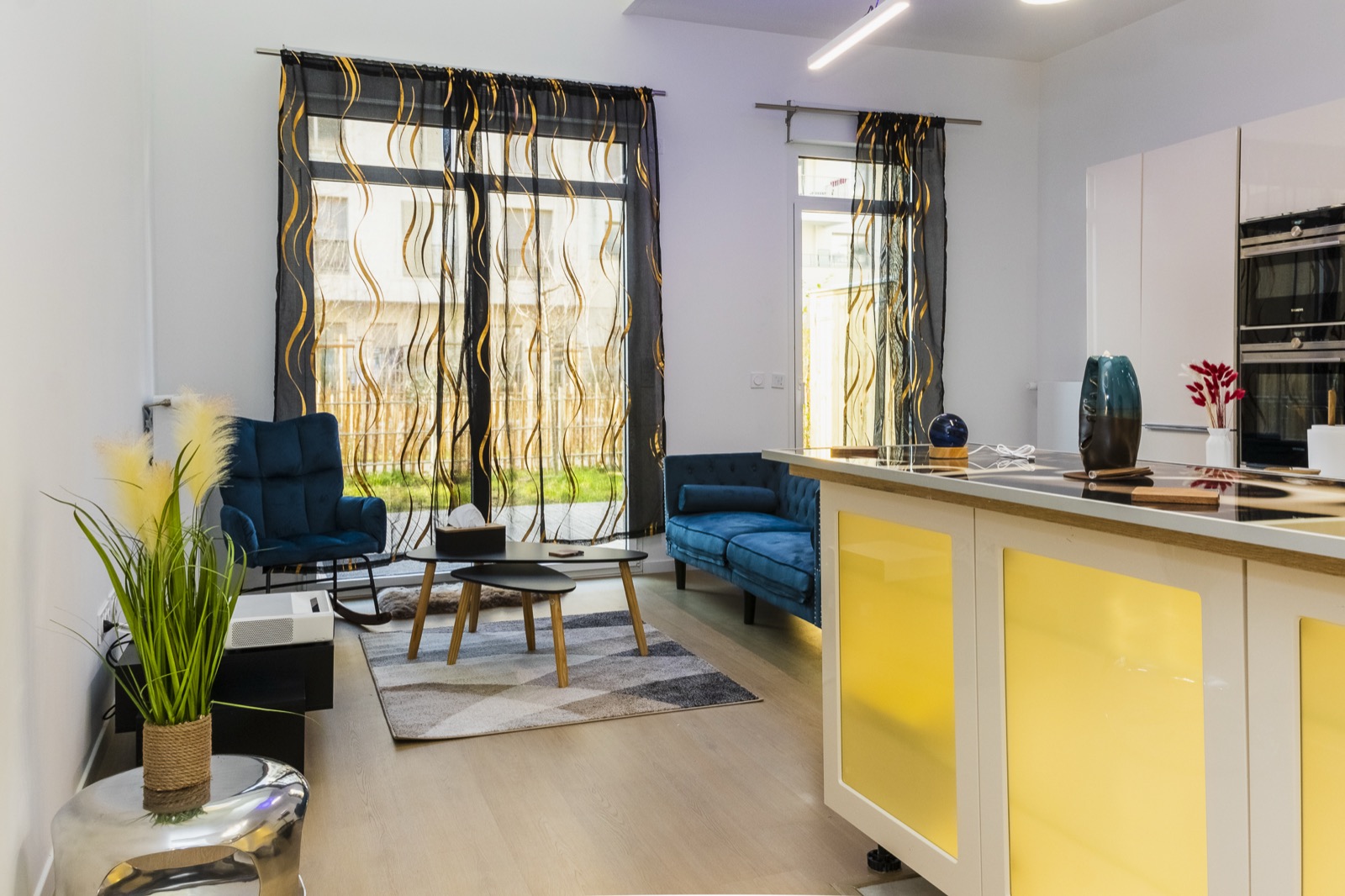 The bright living room of the duplex, opening onto the garden